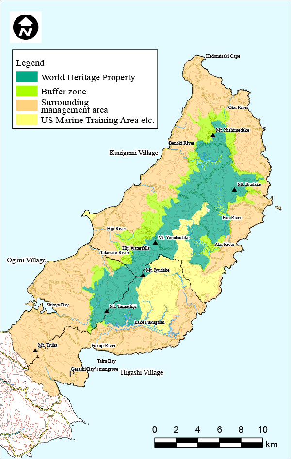 The map of Northern Okinawa Island, encompassing Kunigami, Ōgimi, and Higashi villages, features the central mountain range marked in deep green, signifying the registration area. Surrounding this area, a yellow-green buffer zone is marked, although it is interrupted by the Northern Training Area in the southeast. The rest of the land outside these zones are highlighted in orange, indicating peripheral regions. 